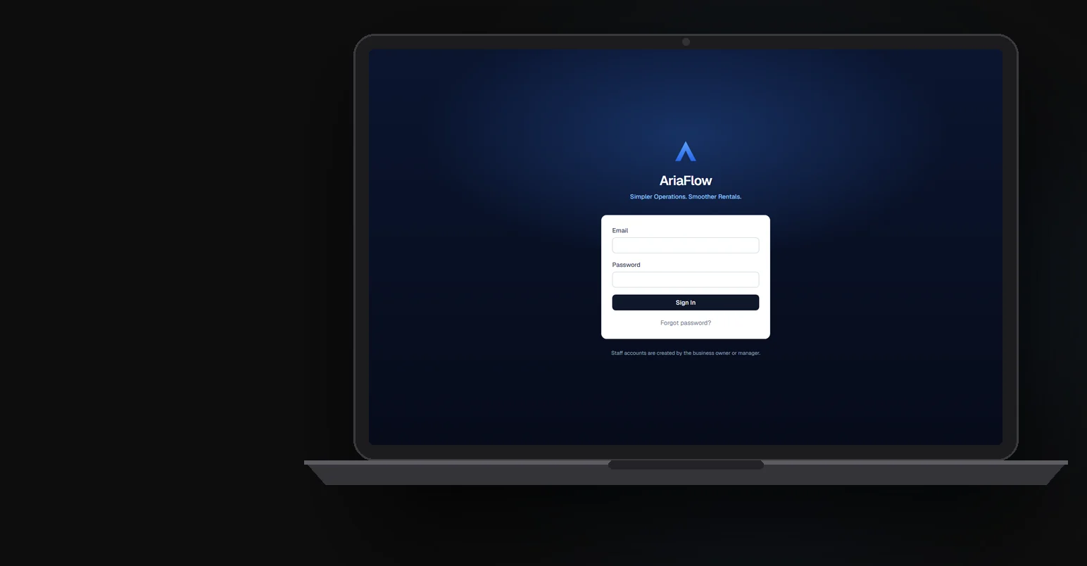 A laptop on a desk showing the AriaFlow sign-in screen